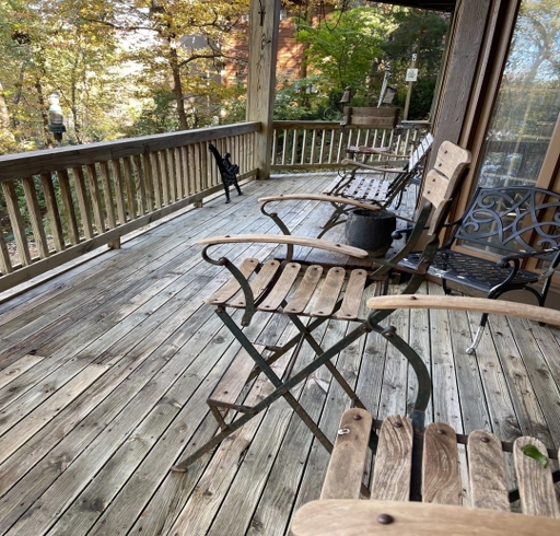 A weathered looking deck with chairs.