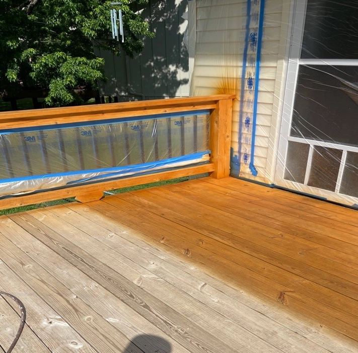 This is a picture of a deck in Olathe, KS that is in the process of being stained by Royal Blue Power Washing.